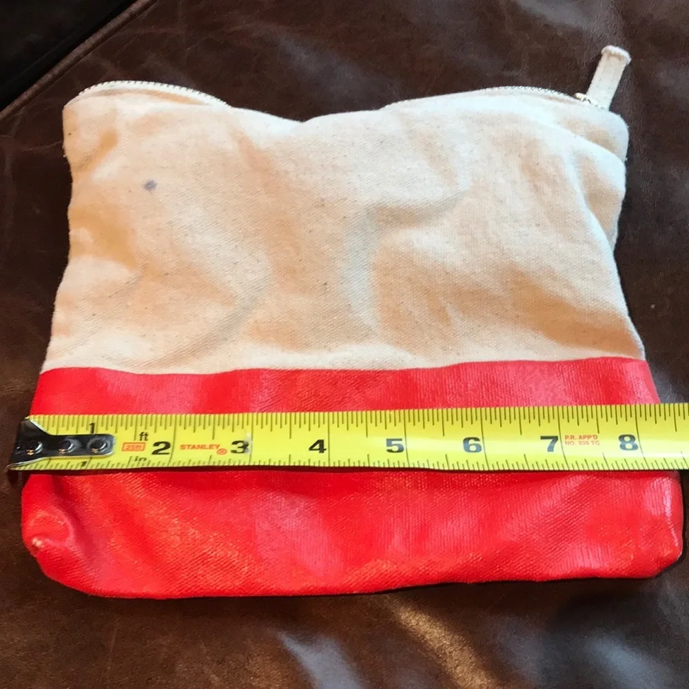 Cosmetic or pencil bag with vinyl orange bottom